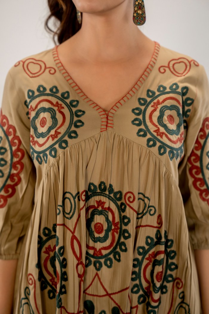 Bohemian Elegance: Beige Dress with Artistic Circular Flair
