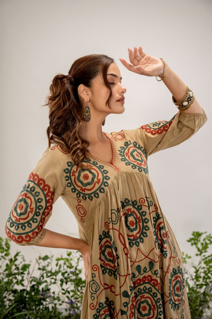Bohemian Elegance: Beige Dress with Artistic Circular Flair