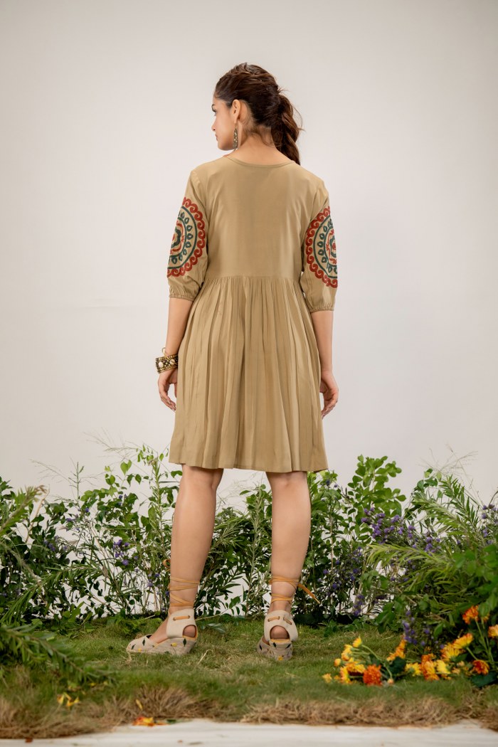 Bohemian Elegance: Beige Dress with Artistic Circular Flair